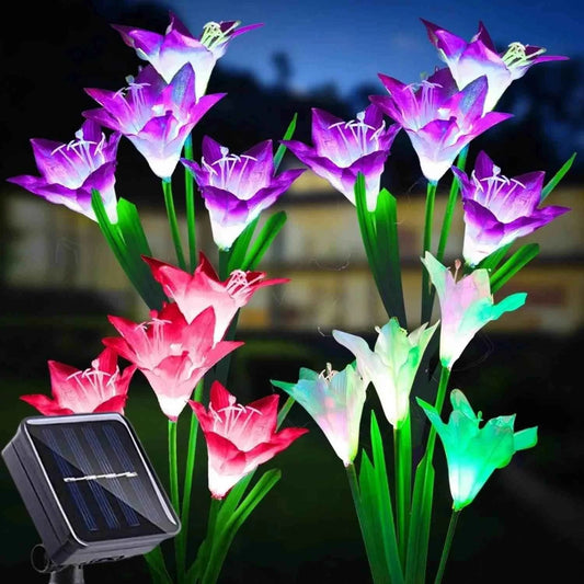 Colorful outdoor solar lily garden lights illuminating a landscaped pathway at night